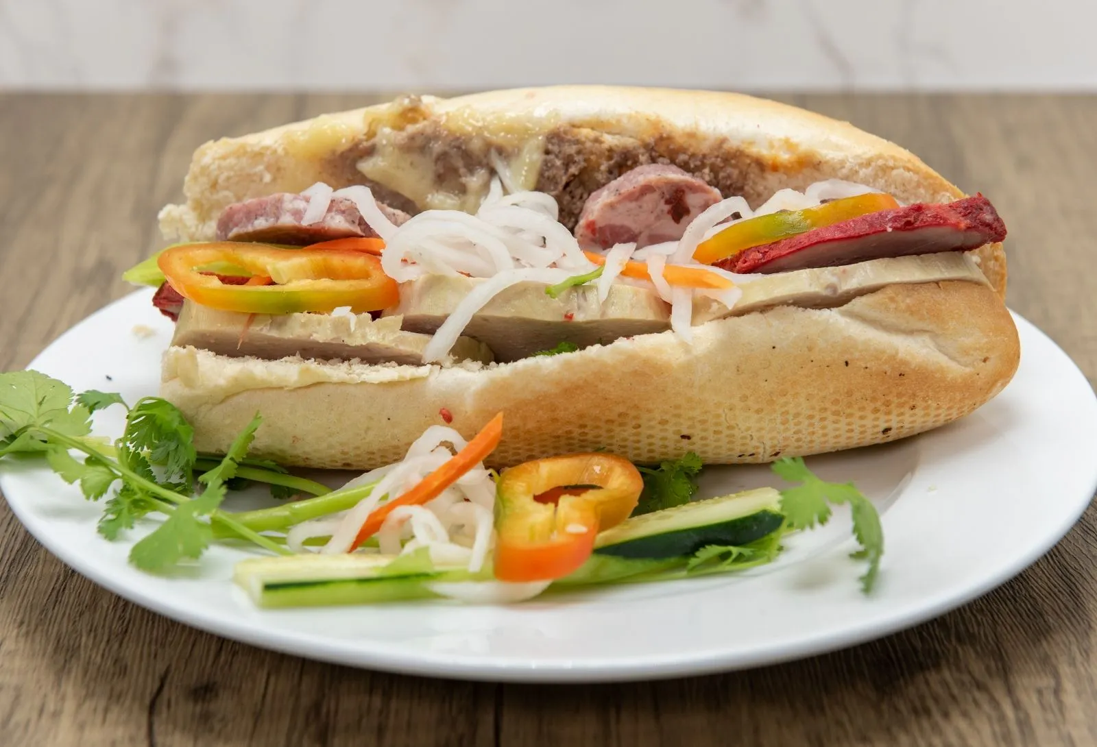 Loaded traditional banh mi with assorted cured pork, peppers and pickled radish at Pho Kitchen, a Vietnamese Restaurant in San Jose