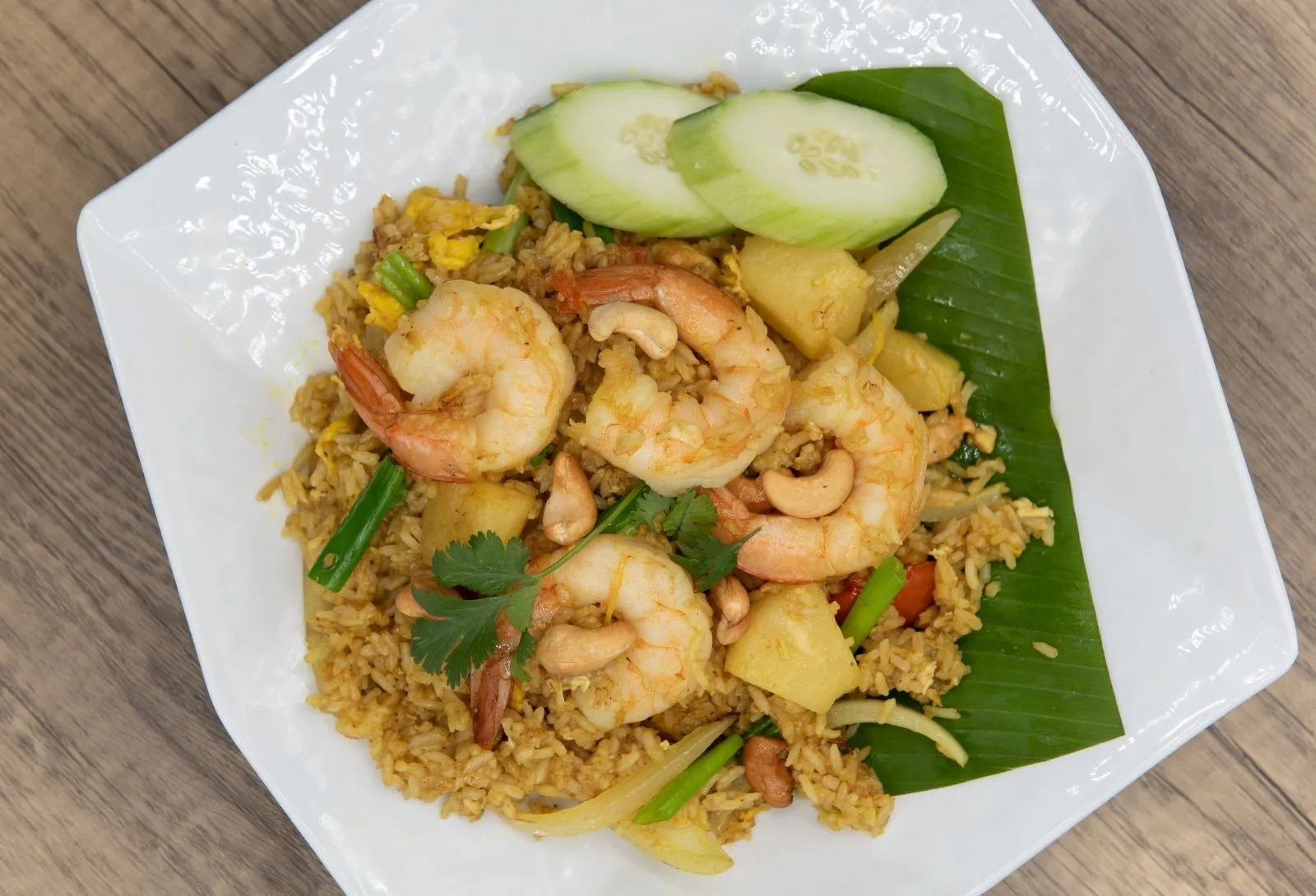Pineapple shrimp fried rice garnished with cashews, herbs and cucumber slices at Pho Kitchen, a Vietnamese Restaurant in San Jose